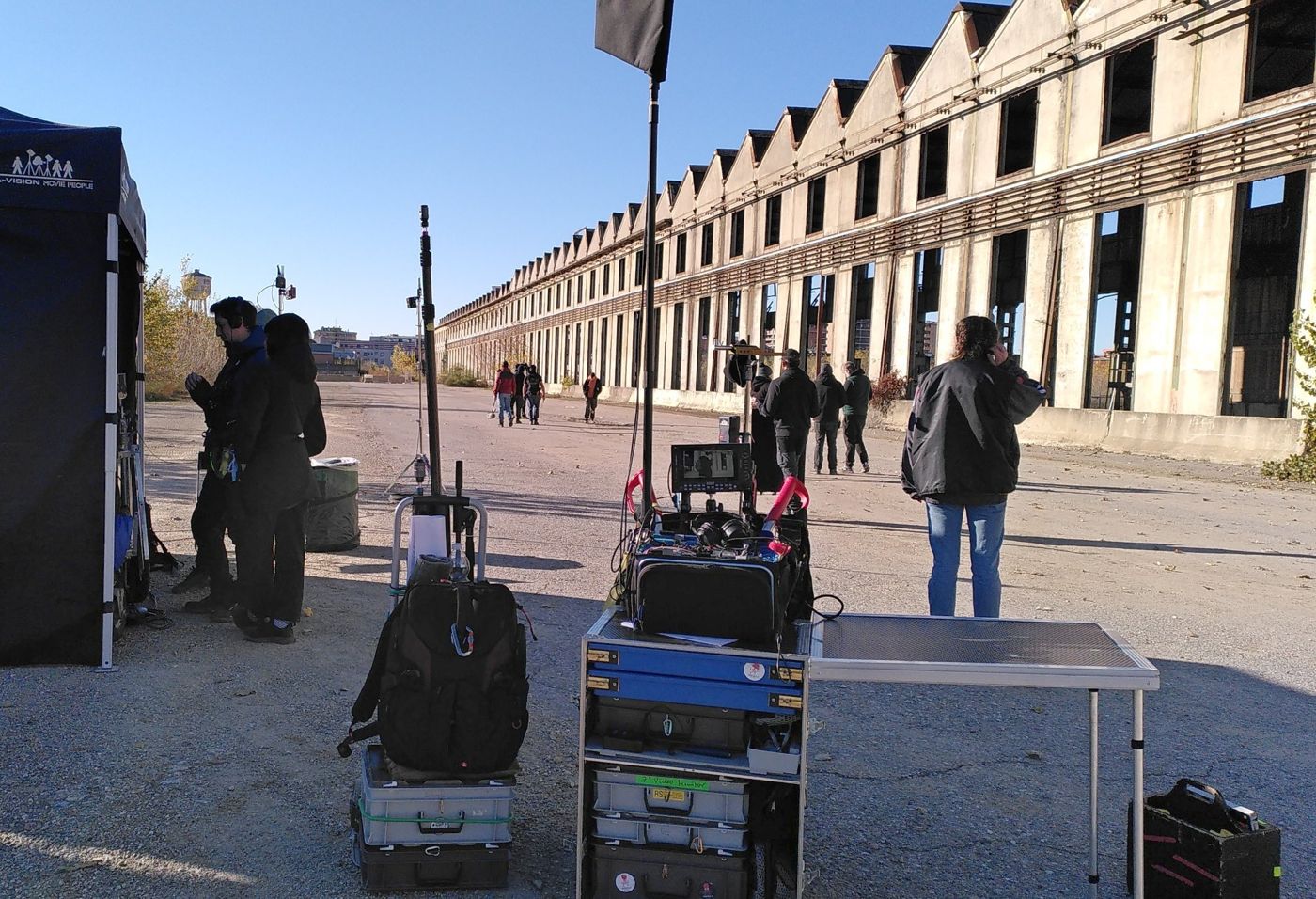 Sound cart and boom poles on location in front of an old factory hall